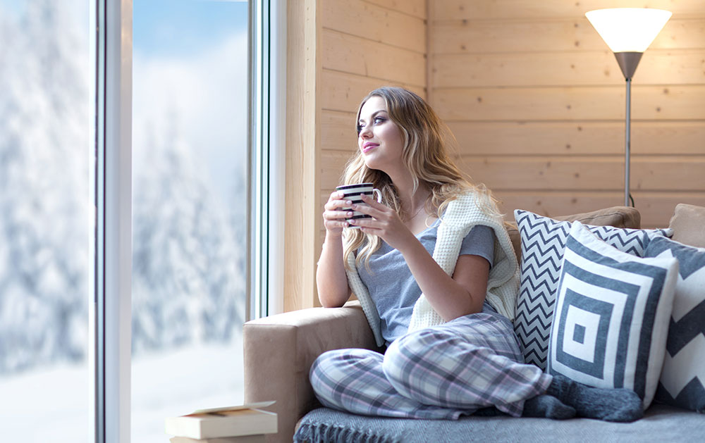 A woman who is happy after getting heating system services in Center Grove, IN